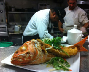 photo - CMC graduate and chef Mark Arriola in the kitchen.